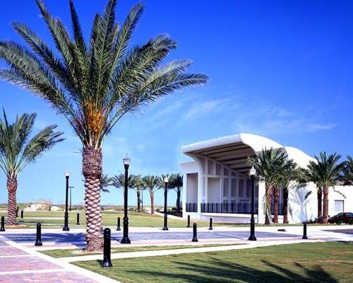 Exterior photo of Sea Walk Pavilion. Palm trees line either side of the venue. Brick sidewalks lead all around the location.